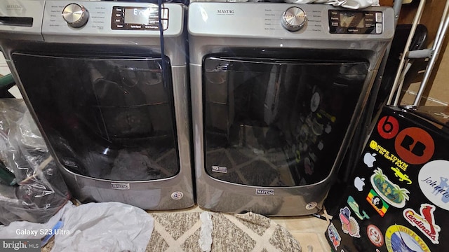 laundry room featuring tile patterned flooring and washer and dryer