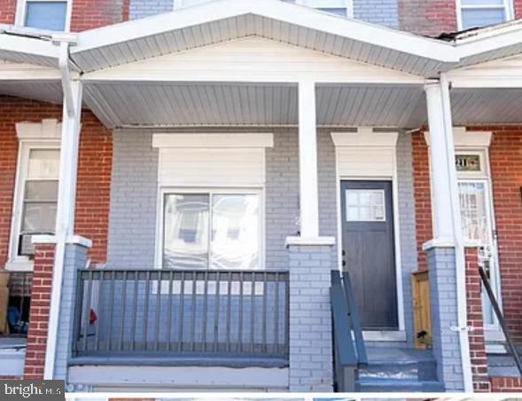 view of exterior entry featuring a porch