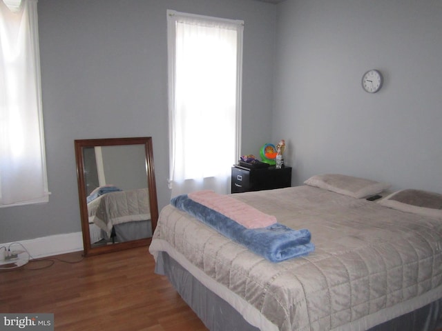 bedroom with wood-type flooring