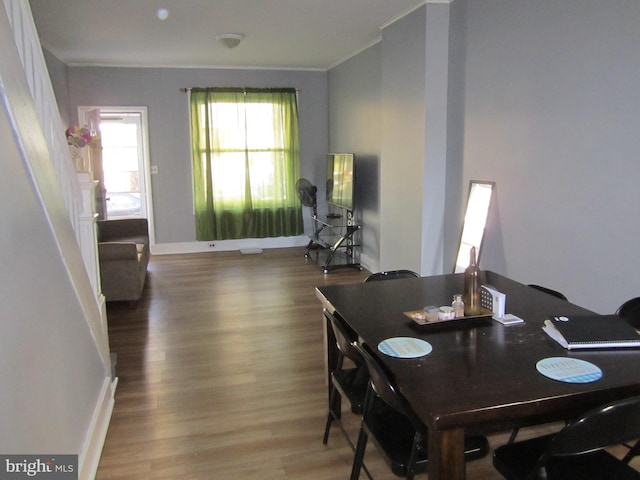 dining room with hardwood / wood-style floors and ornamental molding