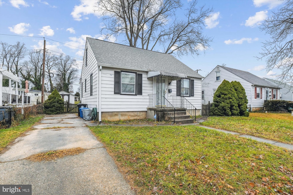 bungalow-style home with a front yard