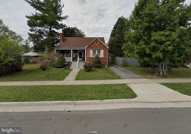 bungalow-style house with covered porch and a front yard