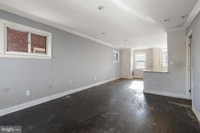 empty room featuring ornamental molding and dark wood-type flooring