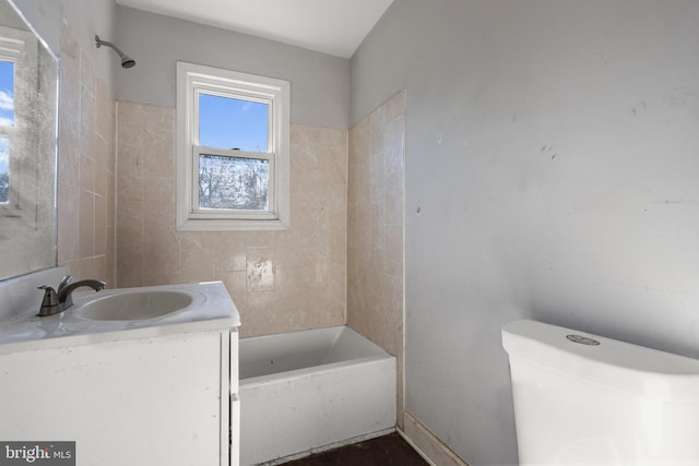 full bathroom featuring vanity, toilet, and tiled shower / bath