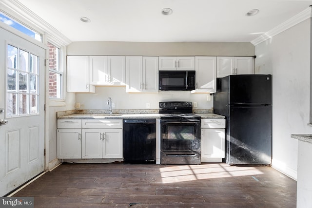 kitchen featuring black appliances, dark hardwood / wood-style floors, white cabinetry, and sink