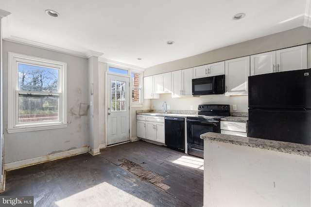 kitchen featuring white cabinets, dark hardwood / wood-style floors, a wealth of natural light, and black appliances