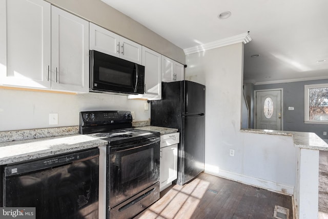 kitchen featuring dark hardwood / wood-style flooring, white cabinetry, crown molding, and black appliances