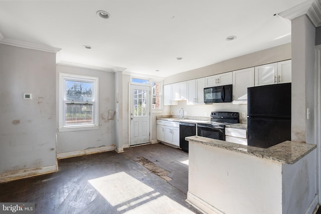 kitchen with dark hardwood / wood-style floors, white cabinetry, and black appliances