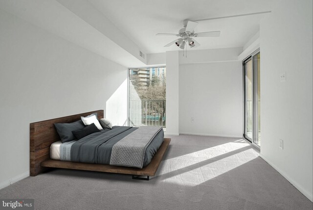 bedroom featuring access to exterior, ceiling fan, light colored carpet, and multiple windows