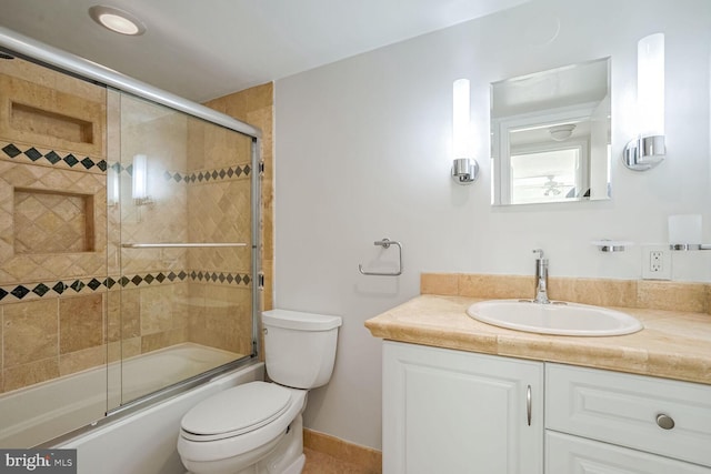 full bathroom with vanity, toilet, and bath / shower combo with glass door