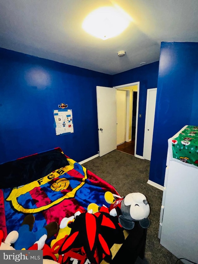 bedroom with dark colored carpet