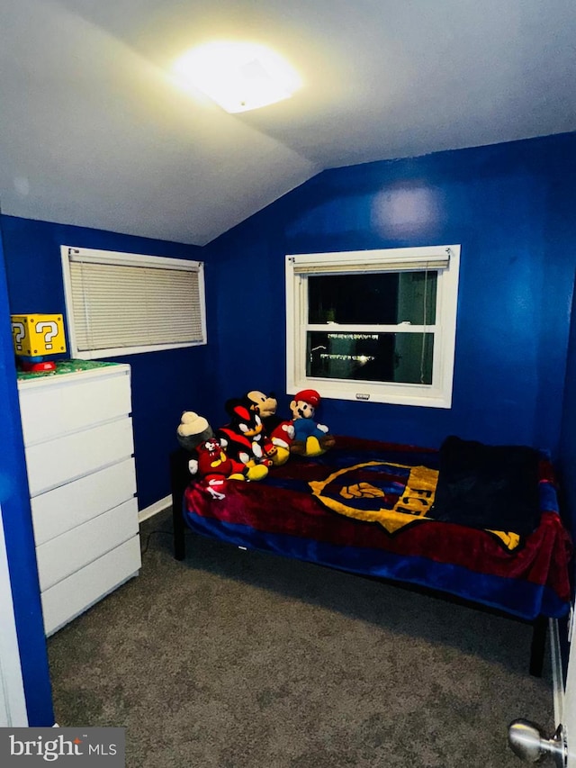 bedroom with dark carpet and lofted ceiling