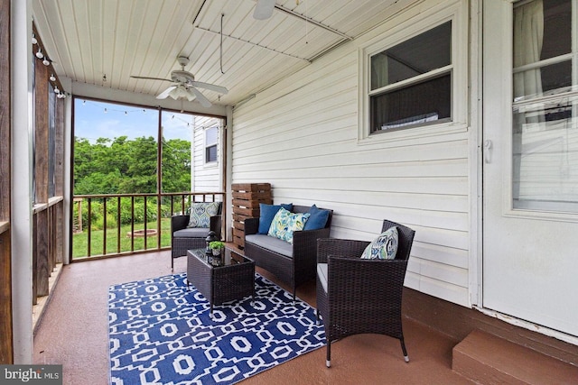 sunroom / solarium featuring ceiling fan and wood ceiling