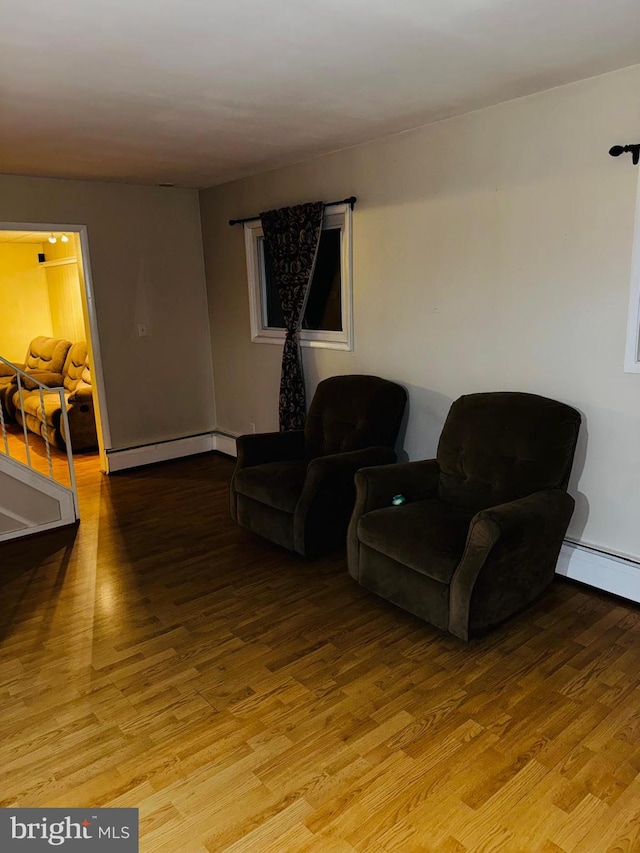 living room featuring light hardwood / wood-style floors and a baseboard radiator