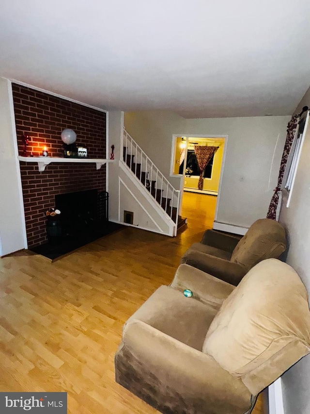 living room featuring a fireplace and wood-type flooring