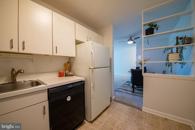 kitchen with ceiling fan, sink, black dishwasher, white fridge, and white cabinetry