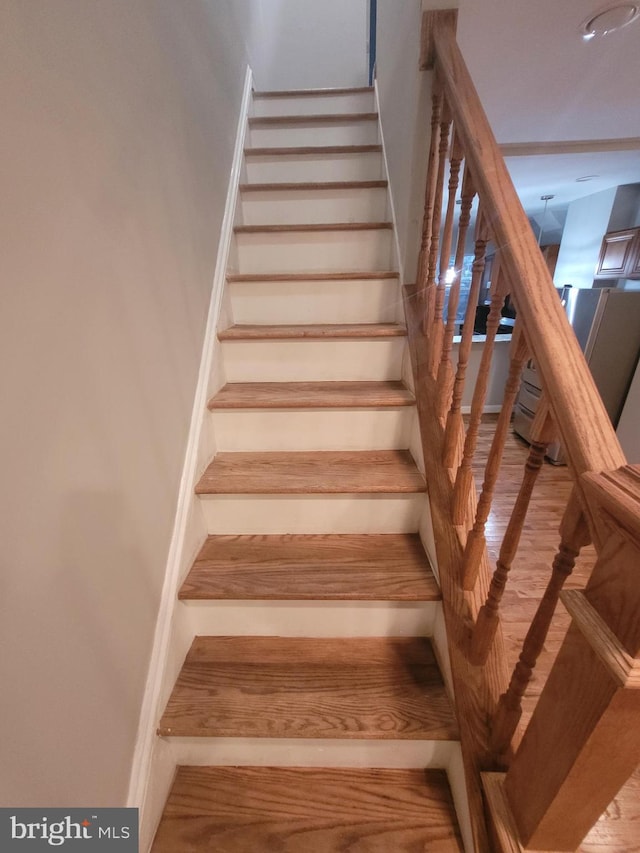 stairs featuring wood-type flooring