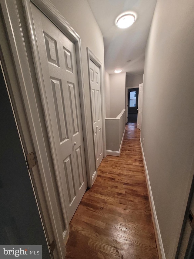 corridor featuring dark wood-type flooring