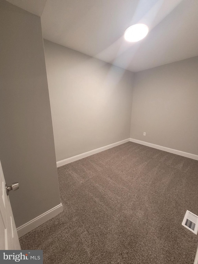 empty room with dark carpet