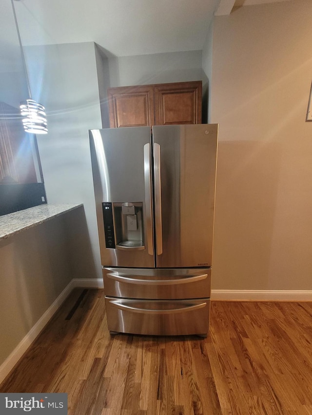 kitchen featuring stainless steel fridge with ice dispenser and wood-type flooring