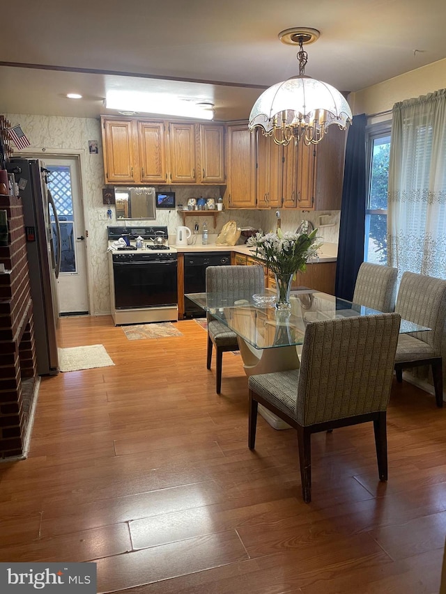 dining area with a chandelier and light hardwood / wood-style flooring