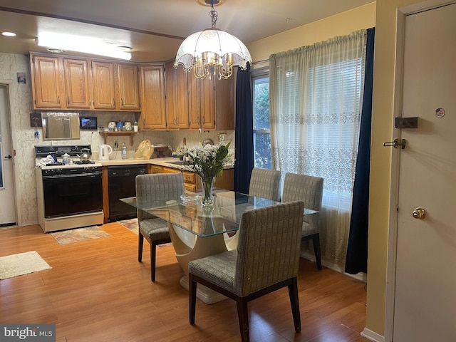 dining area featuring a chandelier and light wood-type flooring