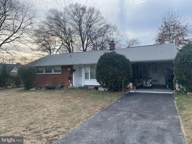 single story home with a carport and a front lawn