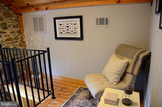 sitting room with wood-type flooring and wooden ceiling