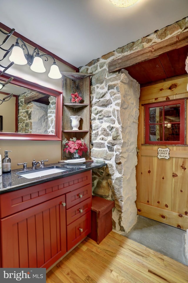 bathroom with vanity and hardwood / wood-style flooring