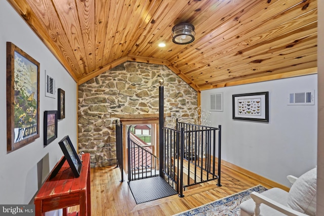 interior space with wood ceiling, lofted ceiling, and hardwood / wood-style flooring