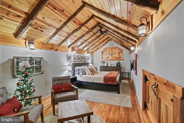 bedroom featuring lofted ceiling with beams, hardwood / wood-style flooring, and wooden ceiling