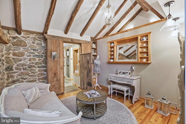 living room featuring light hardwood / wood-style flooring, beamed ceiling, a chandelier, and high vaulted ceiling