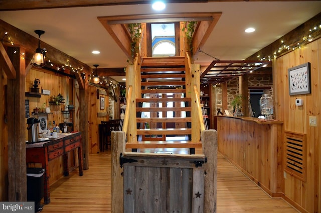 interior space with wooden walls and light wood-type flooring