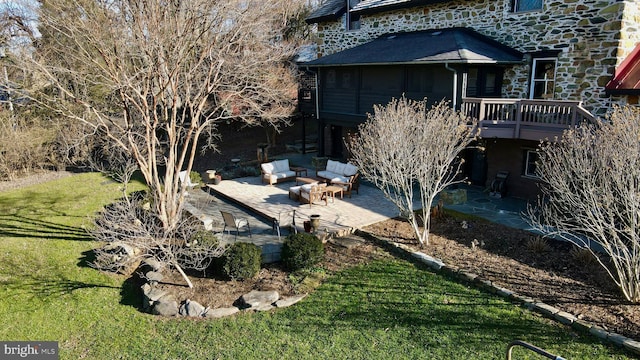 exterior space featuring an outdoor hangout area and a patio area