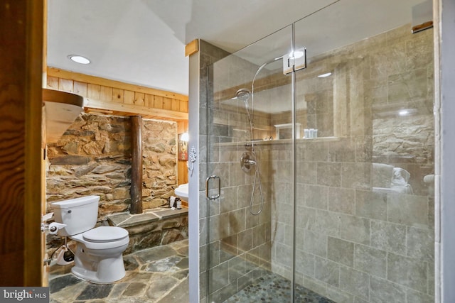 bathroom featuring toilet and an enclosed shower