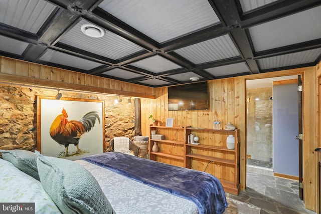 bedroom featuring wooden walls and coffered ceiling