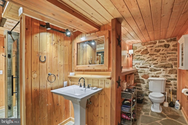 bathroom with wooden walls, wooden ceiling, and toilet