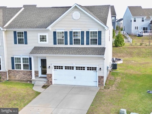 view of front of house featuring a front yard and a garage