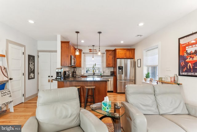 living room with light wood-type flooring and sink