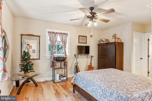 bedroom with ceiling fan and light wood-type flooring