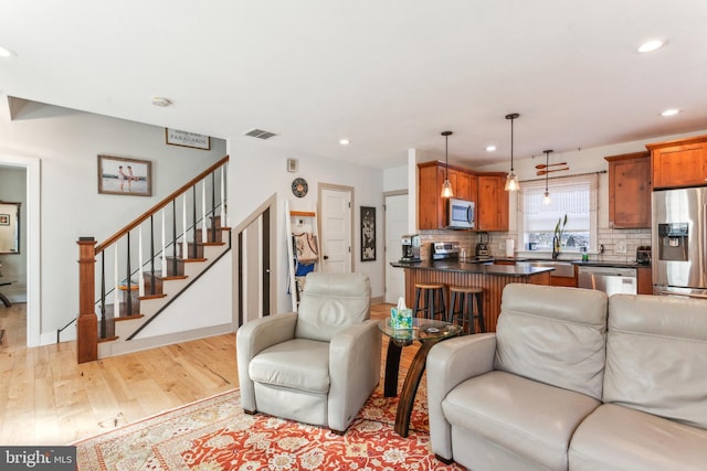 living room featuring light hardwood / wood-style floors and sink