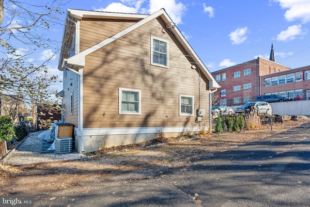 view of side of home featuring central AC unit