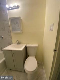 bathroom featuring walk in shower, vanity, and toilet