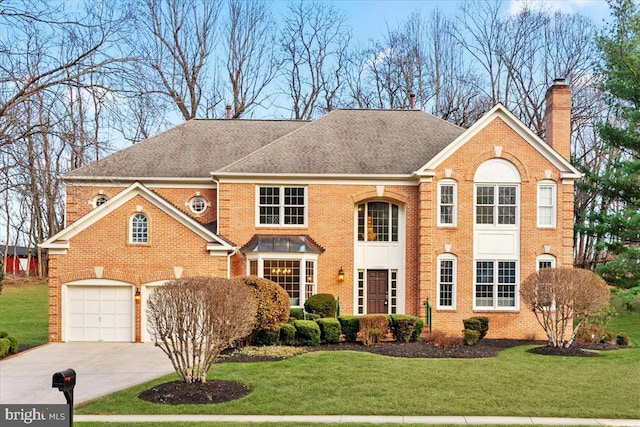 view of property with a front yard and a garage