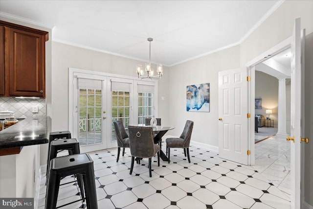 dining area with decorative columns, french doors, a notable chandelier, and ornamental molding