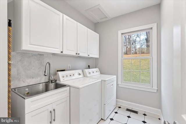 laundry area with washer and dryer, cabinets, and sink