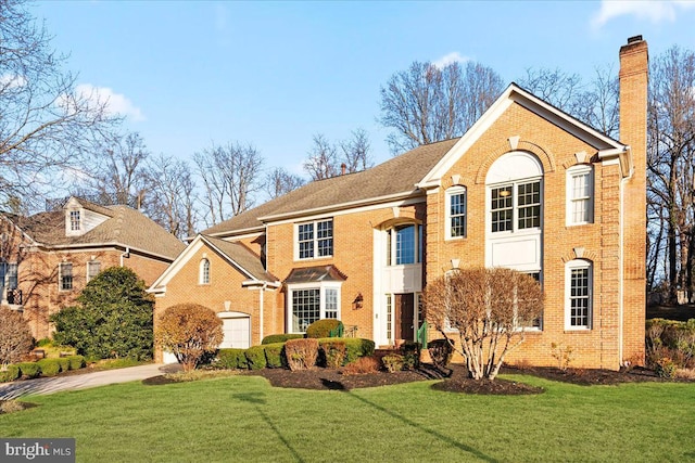 front facade featuring a front lawn and a garage