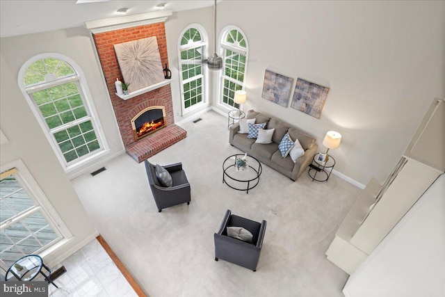 living room featuring a fireplace, light carpet, and a wealth of natural light