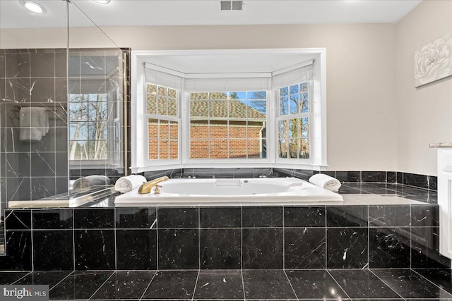 bathroom featuring tiled bath