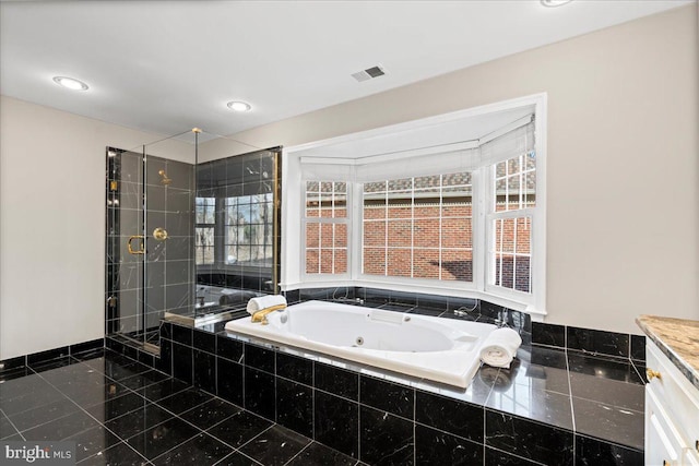 bathroom with vanity and independent shower and bath